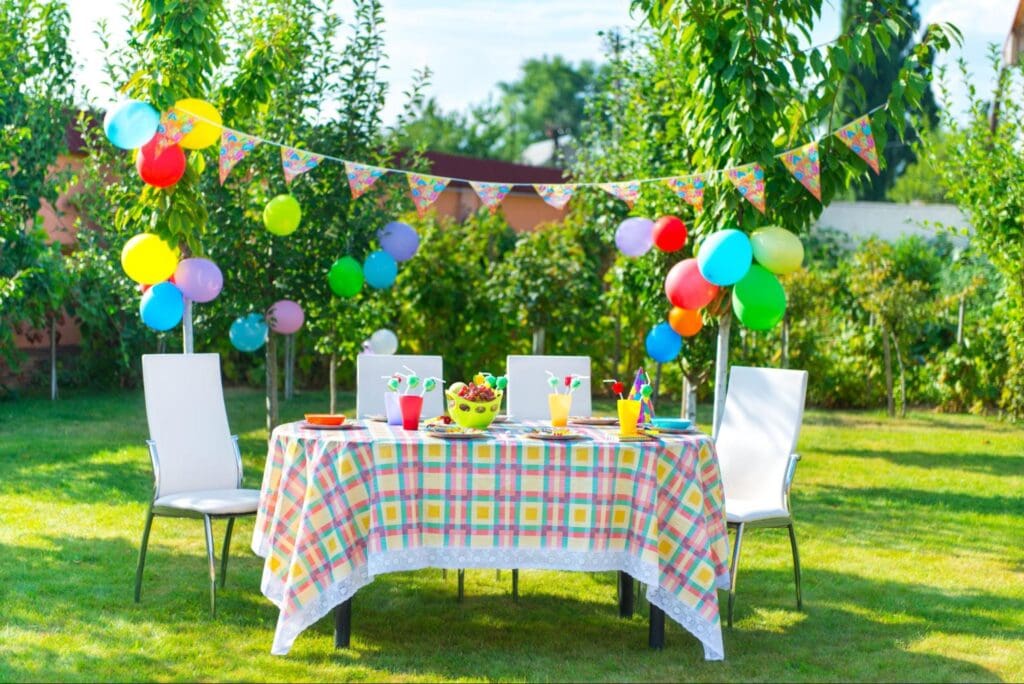 Colorful garden party setup with balloons and decorated table