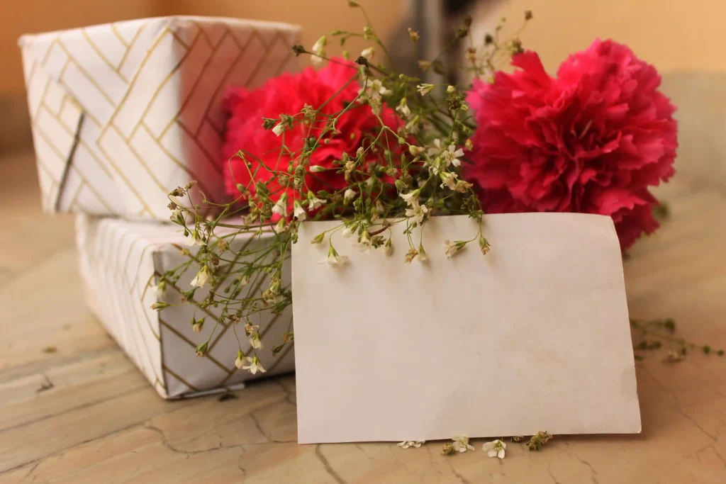 Beautifully wrapped presents with flowers and a blank card, symbolising personalised gift-giving for special occasions.