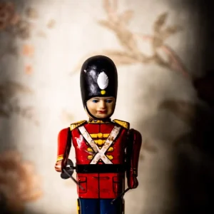 Vintage toy soldier figurine in traditional uniform, adding to the immersive decor of the Fractured room at Escape Room Melbourne.